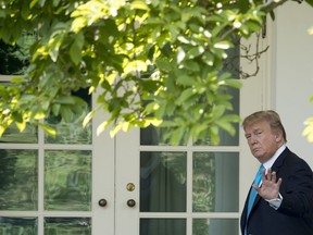 U.S. President Donald Trump waves as he walks towards the Oval Office in Washington, Thursday, May 23, 2019, after visiting the annual Flags In ceremony at Arlington National Cemetery.