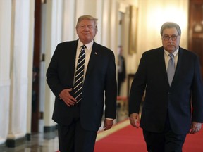 President Donald Trump and Attorney General William Barr arrive for a Public Safety Officer Medal of Valor presentation ceremony in the East Room of the White House, Wednesday, May 22, 2019, in Washington.