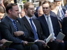 White House Social Media Director Dan Scavino, left, Eric Trump, center, and White House senior adviser Jared Kushner wait for the arrival of President Donald Trump to present golfer Tiger Woods with the Presidential Medal of Freedom, in the Rose Garden of the White House, Monday, May 6, 2019, in Washington.