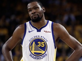 In this Wednesday, May 8, 2019, file photo, Golden State Warriors' Kevin Durant, left, walks away from referee Ken Mauer during the first half of Game 5 of the team's second-round NBA basketball playoff series against the Houston Rockets in Oakland, Calif.