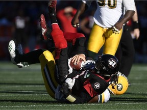 Ottawa Redblacks quarterback Trevor Harris (7) gets sacked by Edmonton Eskimos defensive end Kwaku Boateng (93) in Ottawa on Saturday, Sept. 22, 2018.