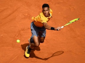 Canada's Felix Auger Aliassime returns the ball to Spain's Rafael Nadal during their Madrid Open match at the Caja Magica in Madrid on May 8, 2019.