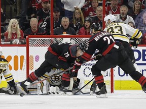 Carolina Hurricanes' Micheal Ferland (79) and Nino Niederreiter (21) try to score on Boston Bruins goalie Tuukka Rask during the first period in Game 3 of their Eastern Conference final series on Tuesday in Raleigh, N.C. (Gerry Broome/The Associated Press)