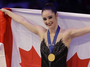 Kaetlyn Osmond of Canada celebrates after winning the women's free skating program, at the Figure Skating World Championships in Assago, near Milan, Italy, Friday, March 23, 2018.
