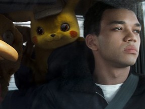 Pikachu (voice of Ryan Reynolds), left,  and Justice Smith in "Pokemon: Detective Pikachu." (Warner Bros. Pictures)