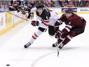 Canada defenceman Philippe Myers battles for the puck with Latvia defenceman Kristaps Zile during first period IIHF World Junior Championship hockey action in Toronto on Thursday, December 29, 2016.