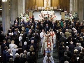 Pallbearers follow clergymen as they exit the Holy Rosary Roman Catholic Church with the coffin of NHL legend Leonard Patrick "Red" Kelly in Toronto, Friday, May 10, 2019. THE CANADIAN PRESS/Cole Burston