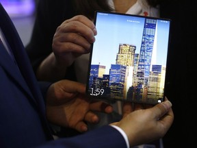In this Tuesday, Feb. 26, 2019 file photo, a man holds the new Huawei Mate X foldable 5G smartphone during the Mobile World Congress wireless show, in Barcelona, Spain.