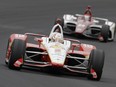 Josef Newgarden leads Ed Jones, of United Arab Emirates, through the first turn during the Indianapolis 500 IndyCar auto race at Indianapolis Motor Speedway, Sunday, May 26, 2019, in Indianapolis.