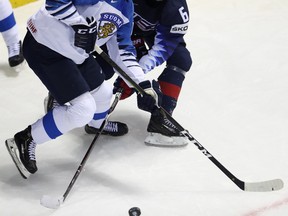 Finland’s Kaapo Kakko (left) and American forward Jack Hughes battle for the puck during the world championship in Slovakia last month. Hughes is expected to go first overall in the NHL draft later this month, but Kakko should give him a run for his money. AP FILES