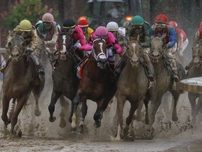 Luis Saez riding Maximum Security, second from right, goes around turn four with Flavien Prat riding Country House, left, Tyler Gaffalione riding War of Will and John Velazquez riding Code of Honor, right, during the 145th running of the Kentucky Derby horse race at Churchill Downs Saturday, May 4, 2019, in Louisville, Ky.