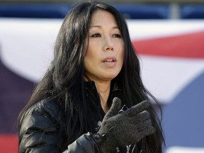 In this Dec. 23, 2018, file photo, Buffalo Bills co-owner Kim Pegula stands on the field as the team warms up before an NFL game against the New England Patriots, in Foxborough, Mass.