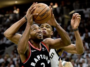 Bucks’ Giannis Antetokounmpo tries to stop Raptors’ forward Kawhi Leonard as he looks for the shot during Game 1 of their Eastern Conference final on Wednesday night in Milwaukee. (FRANK GUNN/THE CANADIAN PRESS)
