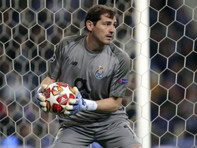 In this Wednesday, April 17, 2019 file photo, Porto goalkeeper Iker Casillas holds the ball during their Champions League quarterfinals, 2nd leg, soccer match against Liverpool at the Dragao stadium in Porto, Portugal. Veteran goalkeeper Iker Casillas has had a heart attack but is out of danger, Porto said Wednesday, May 1. The Portuguese club said Casillas fell ill during a practice session and remains hospitalized, but the "heart condition has been resolved."