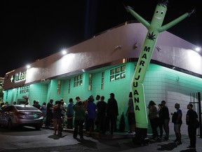 In this July 1, 2017, file photo, people line up at the NuLeaf marijuana dispensary in Las Vegas. (AP Photo/John Locher, File)
