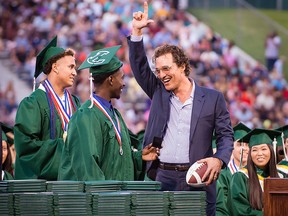 Longview Lobos Kamden Perry, left, and Jephaniah Lister present actor and 1988 Longview High School graduate Matthew McConaughey with an autographed football and his own state championship ring at the school's graduation ceremony in Longview, Texas, on Friday, May 17, 2019.