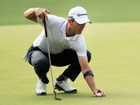 Mike Weir lines up a putt on the first green during the first round of the Masters at Augusta National Golf Club in Augusta, Ga., on April 11, 2019.