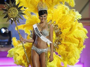 In this July 18, 2006 file photo, Miss Uruguay, Fatimih Davila, shows off a costume related to her home country during the preliminary competition for Miss Universe 2006 at the Shrine Auditorium in Los Angeles. (AP Photo/Lucas Jackson, File)