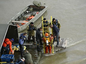A diver descends a ladder to dive to the wreckage as rescuers work to prepare the recovery of the capsized boat under Margaret Bridge in Budapest, Hungary, Thursday, May 30, 2019.