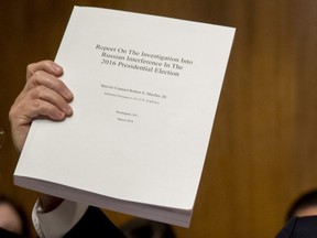 Chairman Sen. Lindsey Graham, R-S.C., holds up a copy of the Mueller Report during a Senate Judiciary Committee hearing on Capitol Hill in Washington, May 1, 2019.