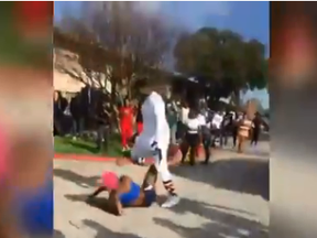 Screenshot of Muhlaysia Booker being viciously attacked in a video that was circulated widely on the internet.
