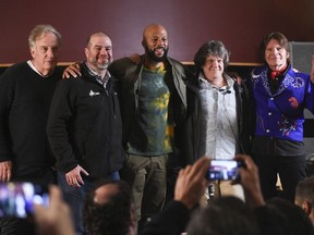 In this Tuesday, March 19, 2019 file photo, comedy writer Alan Zweibel, left, HeadCount executive director Andy Bernstein, hip hop recording artist Common, left, Woodstock co-producer and co-founder, Michael Lang and musician John Fogerty participate in the Woodstock 50 lineup announcement at Electric Lady Studios in New York. A dispute over the future of the Woodstock 50 festival has spiraled into a court fight, with organizers suing and at least temporarily silencing a former investor that sought to call off the anniversary show.