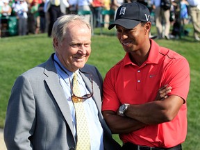 In this June 3, 2012, file photo, Jack Nicklaus, left, talks with Tiger Woods after Woods won the Memorial golf tournament at the Muirfield Village Golf Club in Dublin, Ohio.