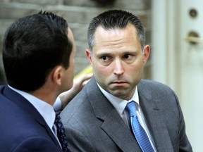 In this June 12, 2018 file photo, Thomas Tramaglini, right, the Kenilworth Schools superintendent accused of defecating on the track at Holmdel High School, makes his initial appearance in Holmdel Municipal Court in Holmdel, N.J. Tramaglini has sued the local police department for releasing his mug shot to the news media. He claims Holmdel police violated his constitutional rights by taking the picture and then releasing it after he was issued summonses last year. The suit seeks unspecified monetary damages.