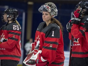 In this Nov. 10, 2018, file photo, Canada goaltender Shannon Szabados watch as U.S. players celebrate a win during the Four Nations Cup gold-medal game in Saskatoon. More than 200 of the world's top female players have taken their next step toward a single, economically viable professional league by forming their own players' association.
