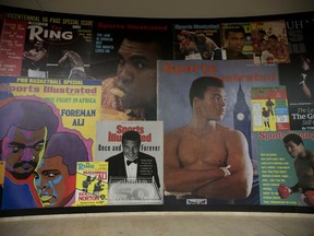 In this June 4, 2016, file photo large posters of mostly Sports Illustrated magazine covers are displayed at the "I Am The Greatest, Muhammad Ali" exhibition at the O2 arena.