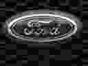 In this Feb. 17, 2019, file photo the company logo is displayed on the grille of an unsold 2019 F150 pickup truck at a Ford dealership in Broomfield, Colo. 