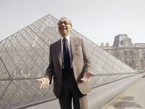 In this March 29, 1989, file photo, Chinese-American architect I.M. Pei laughs while posing for a portrait in front of the Louvre glass pyramid, which he designed, in the museum's Napoleon Courtyard, prior to its inauguration in Paris.