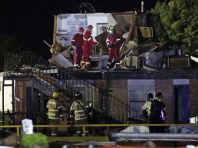 Emergency workers check what is left of the second floor of a hotel, Sunday, May 26, 2019, in El Reno, Ok., following a likely tornado touchdown late Saturday night. (AP Photo/Sue Ogrocki)