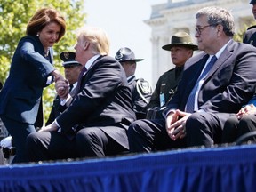 Attorney General William Barr (right) looks on as President Donald Trump shakes hands with Speaker of the House Nancy Pelosi (left), during the 38th Annual National Peace Officers' Memorial Service at the U.S. Capitol in Washington, Wednesday, May 15, 2019.