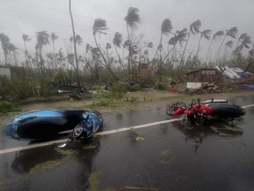 Motorcycles lie on a street in Puri district after Cyclone Fani hit the coastal eastern state of Odisha, India, Friday, May 3, 2019.