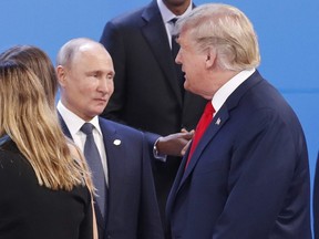 In this Nov. 30, 2018, file photo, U.S. President Donald Trump, right, walk past Russia's President Vladimir Putin, left, as they gather for the group photo at the start of the G20 summit in Buenos Aires, Argentina.