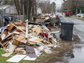 Residents clean up after the flood waters recede in certain sectors Thursday, May 2, 2019 in Ste-Marthe-sur-le-Lac, Que. A dike broke last week causing widespread flooding and forcing thousands of people to evacuate .THE CANADIAN PRESS/Ryan Remiorz ORG XMIT: RYR106