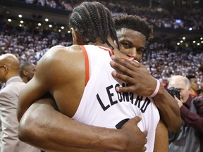Philadelphia 76ers' Jimmy Butler congratulates Raptors' Kawhi Leonard after the game in Toronto on Sunday.