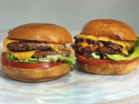 An Original Impossible Burger, left, and a Cali Burger, from Umami Burger, are shown in this photo in New York, Friday, May 3, 2019.