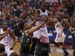 Raptors' Serge Ibaka (centre) is fouled during first half action against the Bucks during Game 4 of the NBA's Eastern Conference Final in Toronto on Tuesday, May 21, 2019.