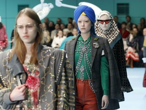 In this Feb. 21, 2018 file photo, models display items from Gucci's women's Fall/Winter 2018-2019 collection, presented during the Milan Fashion Week, in Milan, Italy. The top civil rights organization for Sikhs in the United States says Nordstrom has apologized to the community for selling an $800 turban they found offensive, but they are still waiting to hear from the Gucci brand that designed it, Saturday, May 18, 2019.