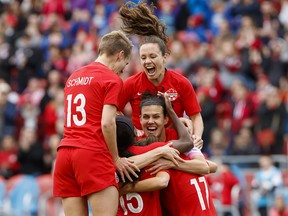 Team Canada captain Christine Sinclair (12) celebrates a goal by midfielder Jessie Fleming (17) with teammates Allysha Chapman (2) and Sophie Schmidt (13) during the first half of a women's international soccer friendly against Mexico at BMO field in Toronto, Saturday, May 18, 2019.