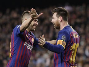 Barcelona's Lionel Messi celebrates with Jordi Alba after scoring his side's third goal during the Champions League semifinal against Liverpool at the Camp Nou stadium in Barcelona, Wednesday, May 1, 2019.