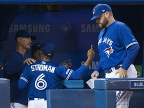 Blue Jays starting pitcher Marcus Stroman argues with Jays pitching coach Pete Walker (left) after being pulled from Saturday's game against the Chicago White Sox during seventh inning.