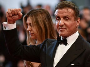 Sylvester Stallone raises his fist as he arrives for the screening of "Homage to Sylvester Stallone - Rambo: First Blood" at the 72nd edition of the Cannes Film Festival in Cannes, France, on Friday, May 24, 2019.