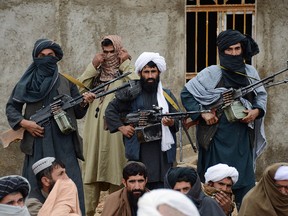 In this Nov. 3, 2015 file photo, Afghan Taliban fighters listen to Mullah Mohammed Rasool, the newly-elected leader of a breakaway faction of the Taliban, in Farah province, Afghanistan. (AP Photo, File)
