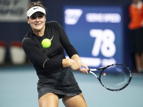 Bianca Andreescu, of Canada, returns a shot to Angelique Kerber, of Germany, during the Miami Open tennis tournament in Miami Gardens, Fla. Sunday, March 24, 2019. Canadian tennis star Bianca Andreescu, who has rocketed up the WTA Tour rankings after a breakout start to the season, has resumed on-court activity after a five-week break to rest a shoulder injury.