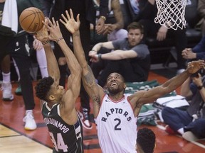 Giannis Antetokounmpo & Kawhi Leonard in 4th quarter action in Game 3 of the Eastern Conference Finals as the Toronto Raptors go on to beat the Milwaukee Bucks, in Toronto, Ont. on Monday May 20, 2019. Stan Behal/Toronto Sun/Postmedia Network