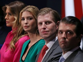 This Oct. 9, 2016 file photo shows family members of Donald Trump, (from left to right) wife Melania Trump, daughter Ivanka Trump, and sons Eric Trump and Donald Trump Jr., as they listen to a presidential debate at Washington University in St. Louis.