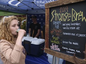 In this photo taken May 18, 2019, a woman tastes a green tea mocha beer at the Strange Brew Festival in Reno, Nev.